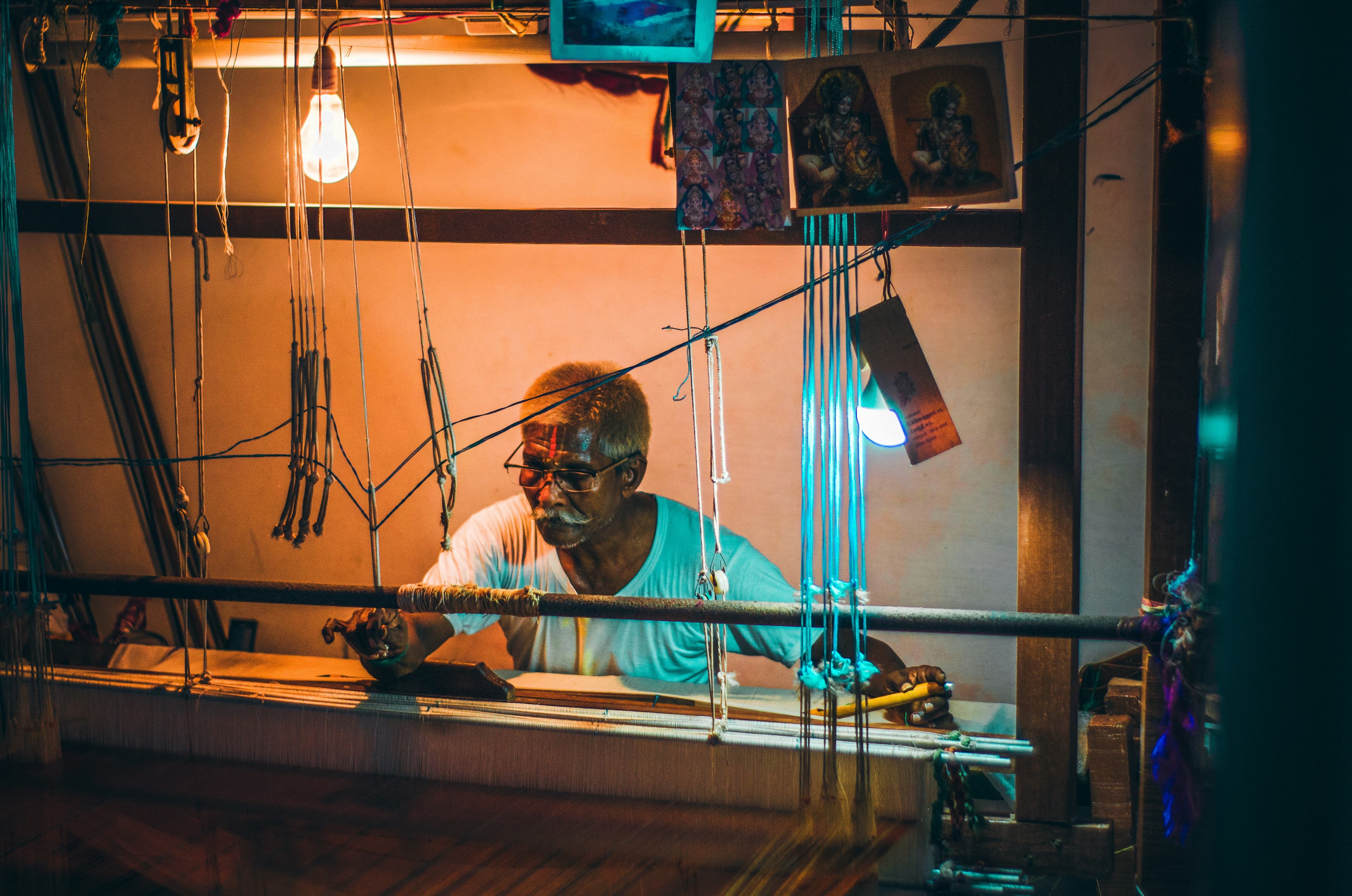 Weaver working by lamplight